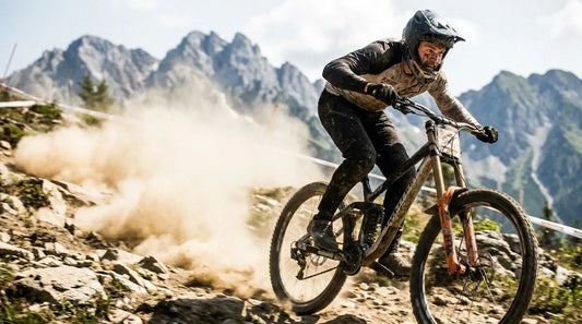 A downhill racer pinning a high-speed rocky section on the Leogang track with a massive dust cloud behind.