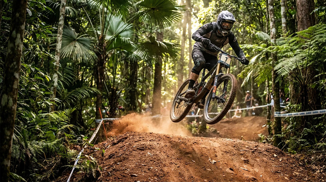 Elite downhill mountain bike racer mid-air over a jump on Smithfield Mountain Bike Park's rainforest course at the 2026 Cairns Rainforest Rumble in Far North Queensland